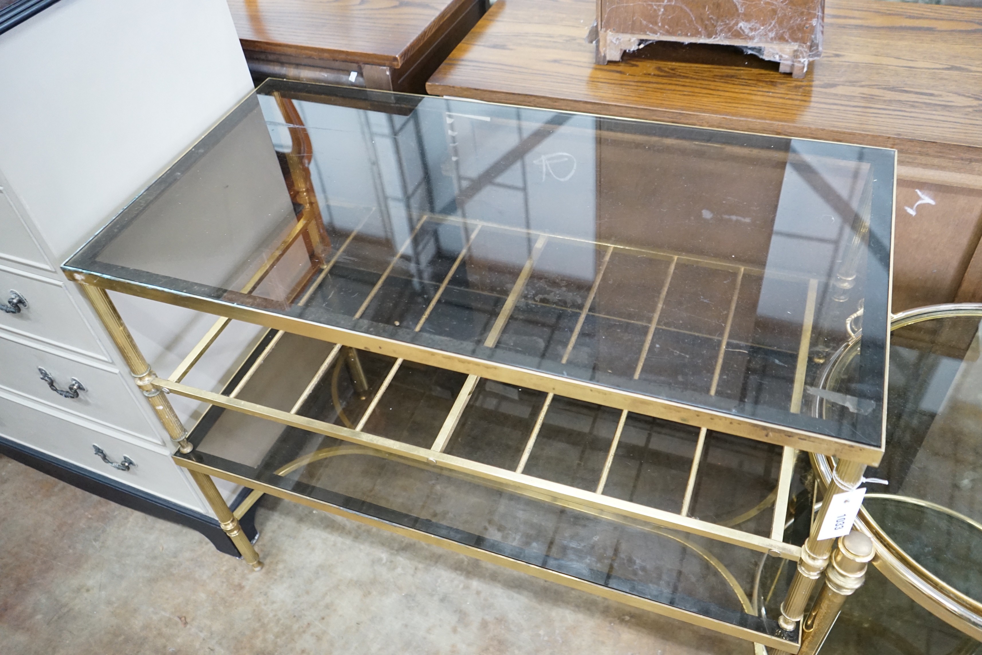 A brass and smoked glass two tier rectangular coffee table, width 99cm, depth 51cm, height 41cm